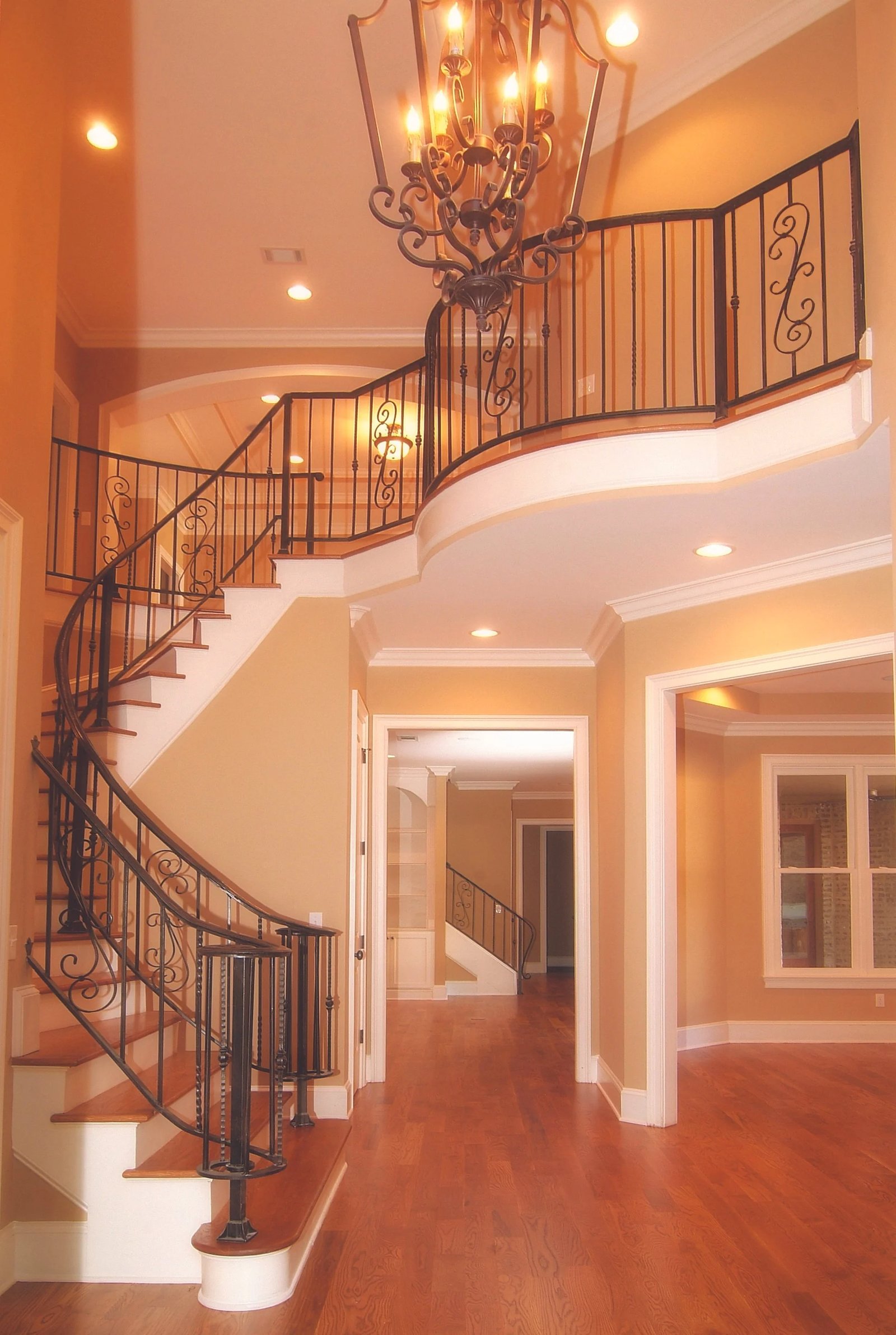 Curved staircase and two-story entry in a Renaissance Homes custom build
