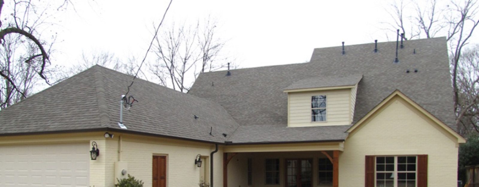 Completed roof replacement showing new shingles, gables and ridge vents